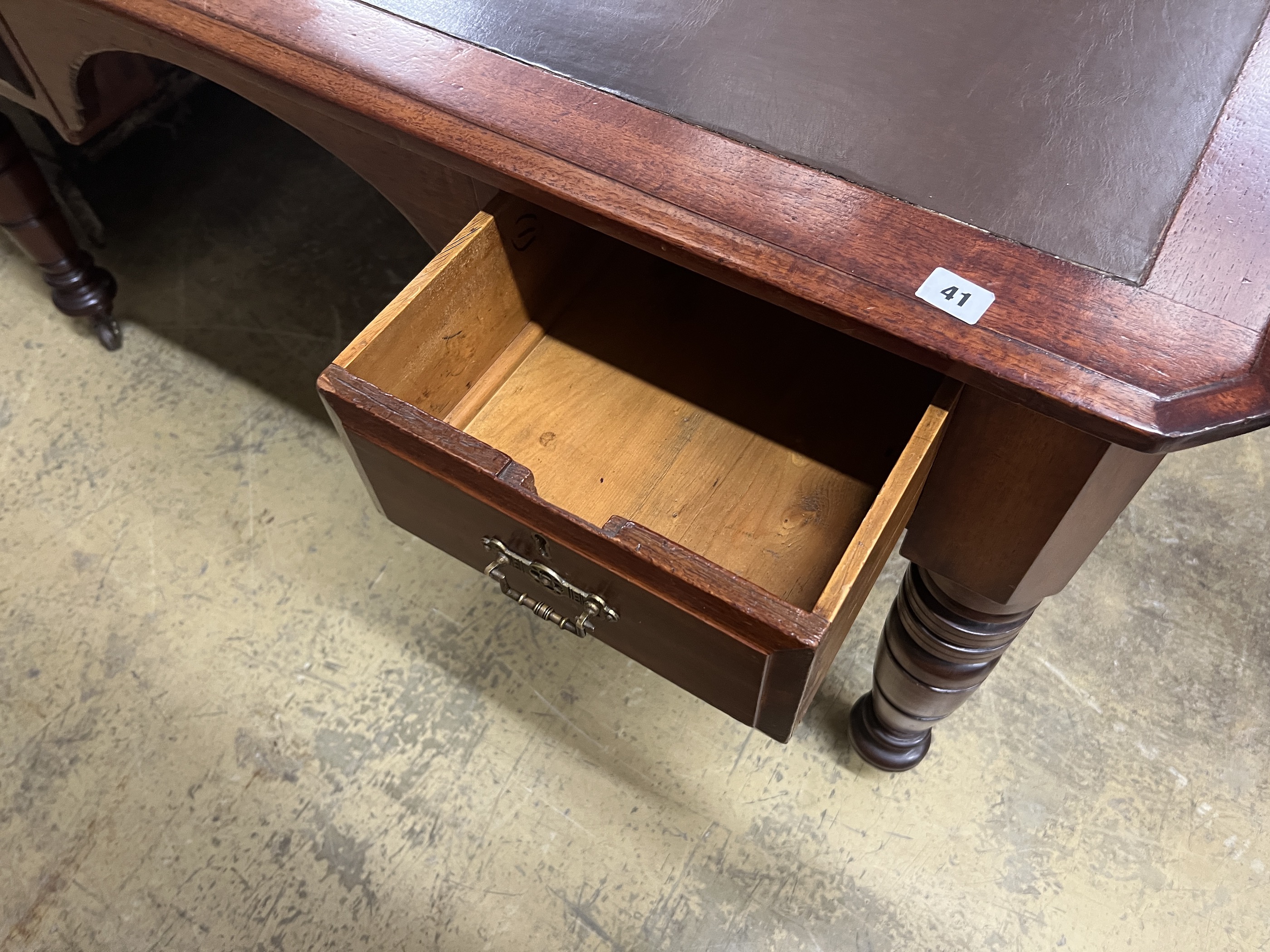 A late Victorian mahogany and cedar kneehole writing table, width 137cm, depth 107cm, height 75cm